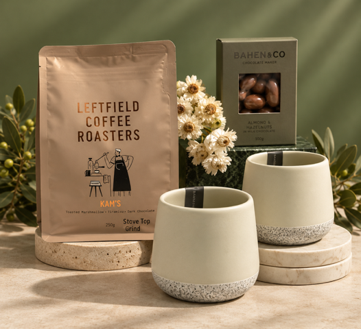 Coffee Blend, ceramic tumblers and chocolate on green background