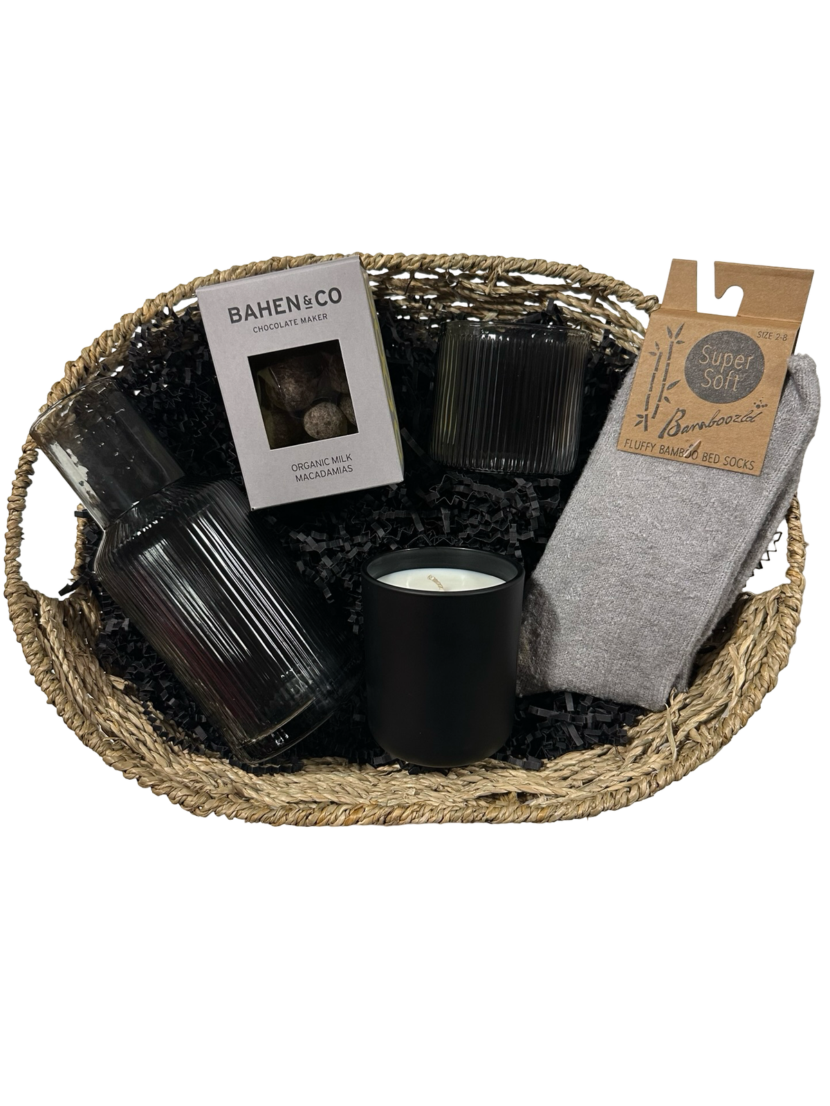 Gift basket with candles, a book, and socks on a white background