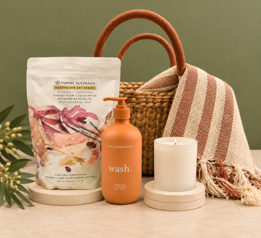 basket with blanket, pamper items and candles on a white background
