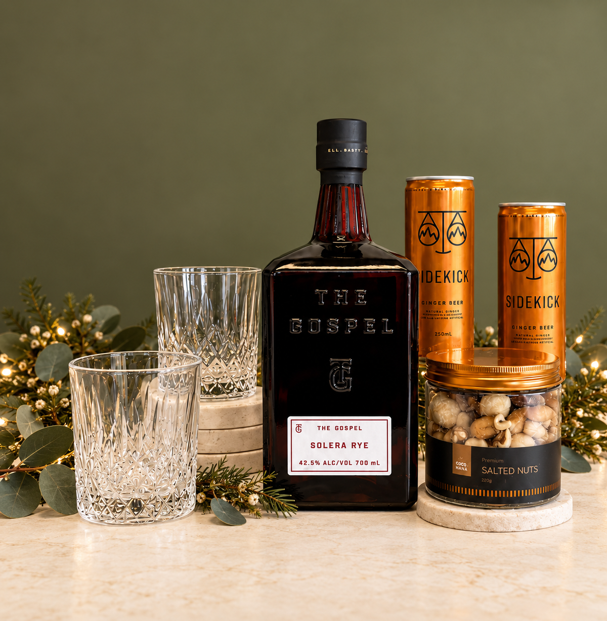 A sophisticated gift for the whiskey lover, featuring The Gospel Solera Rye Whiskey, two classic cut-glass tumblers, premium Sidekick mixers, and a jar of salted nuts for the perfect pairing. Beautifully presented in our signature black gift box, this is a stylish combination of premium spirits, quality mixers and delicious nibbles — perfect for celebrating the festive season in style.