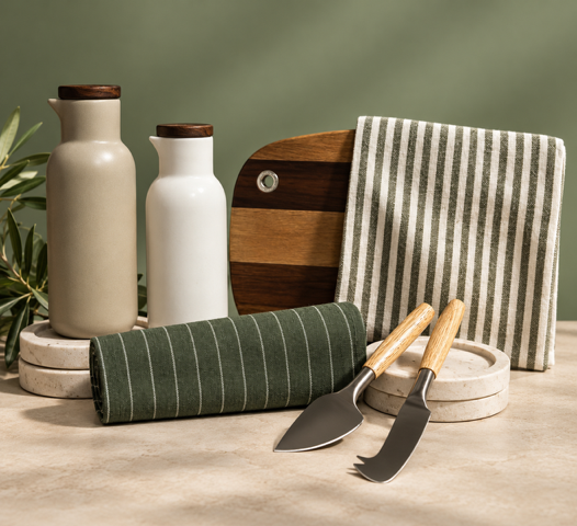 Modern kitchen board and ceramics on green background.