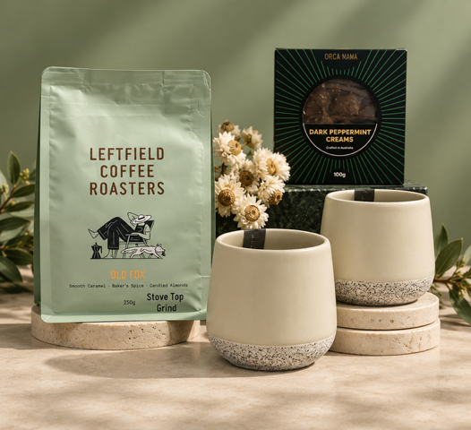 Coffee blend, ceramic tumblers and chocolate on green background