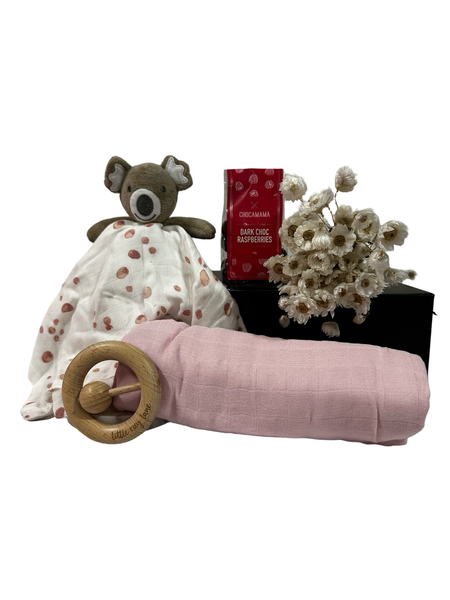 Black gift box with pink swaddle, koala comforter, teether, raspberry chocolates and decorative flowers