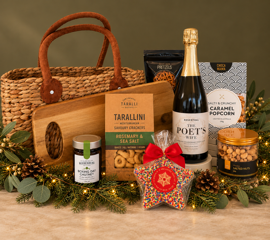 A beautifully curated hamper made for relaxed entertaining and festive celebrations. Presented in a natural woven basket, it brings together a bottle of sparkling wine with gourmet treats including rosemary & sea salt tarallini, crunchy pretzels, salted nuts, caramel popcorn and a delicious Boxing Day chutney.
Finished with a festive sprinkle star, this is a generous and stylish gift that’s perfect for sharing, celebrating and enjoying over the Christmas season.