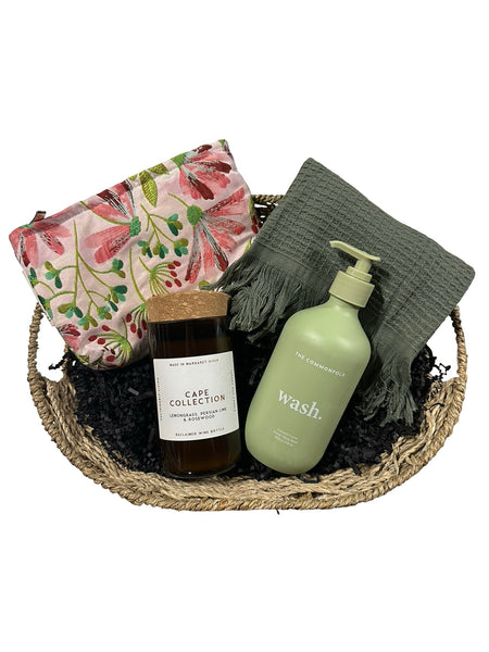 Basket with skincare products and a pouch on a white background