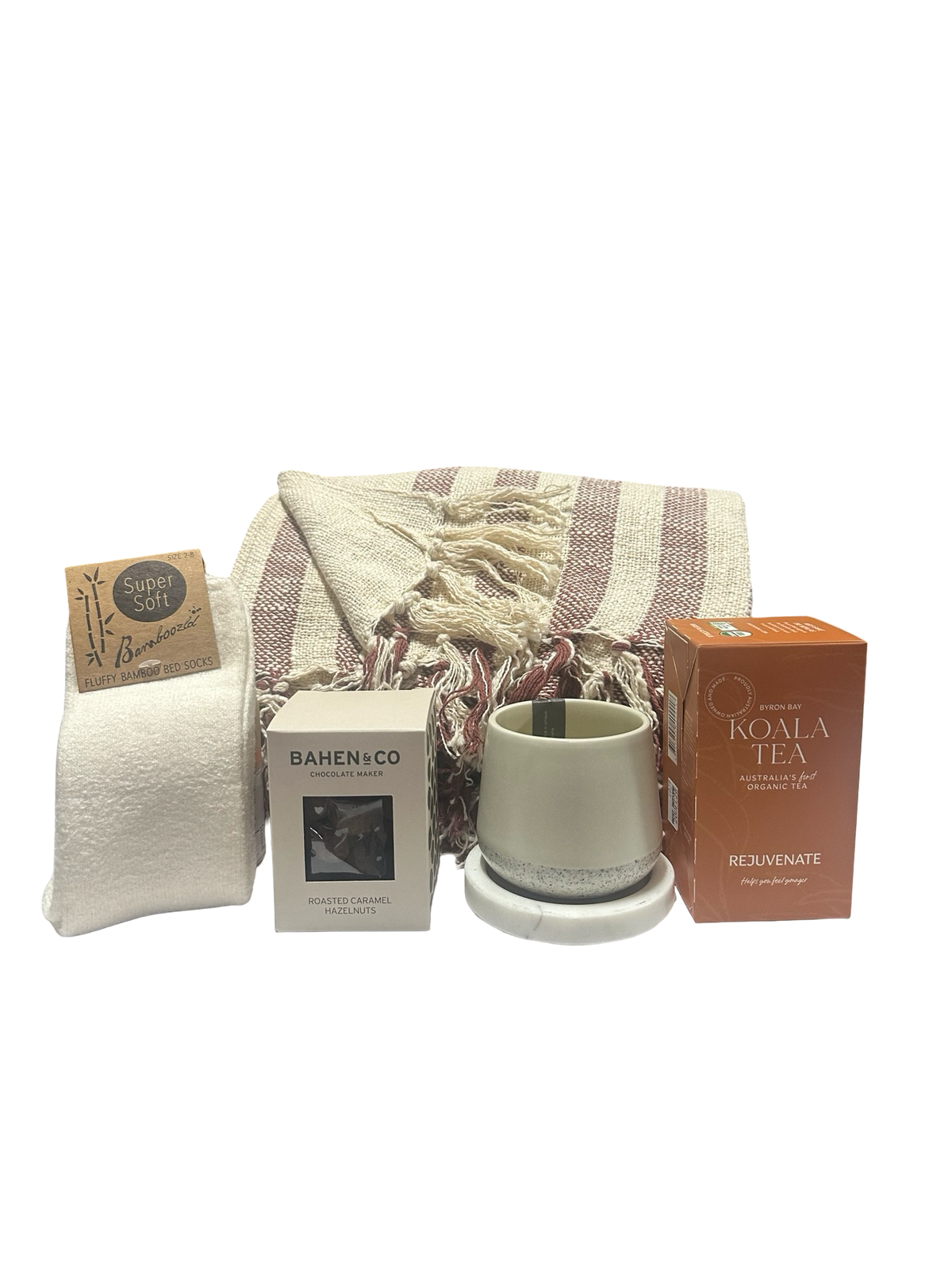 Gift set with a mug, towel, and tea boxes on a white background