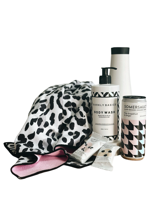 Gym towel, water bottle, body wash, two cans of soda and health treats