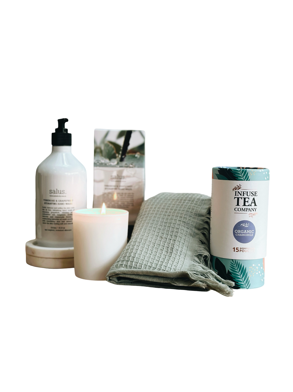 Candle, bottle, towel, and tea packaging on a white background
