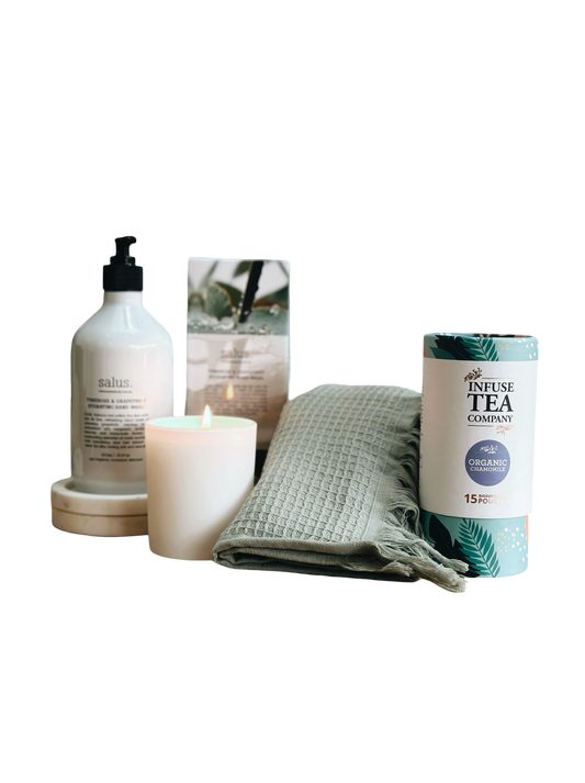 Candle, bottle, towel, and tea packaging on a white background