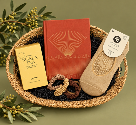 Basket with a red book, beige sock, and other items on a white background