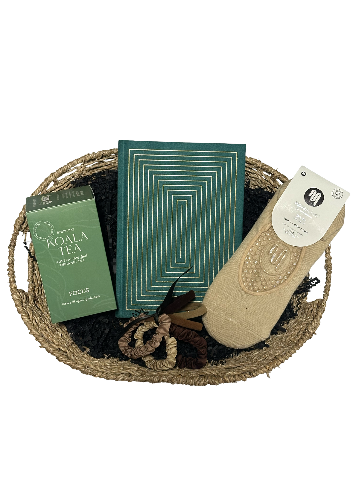 Basket with socks, books, and tea bags on a white background