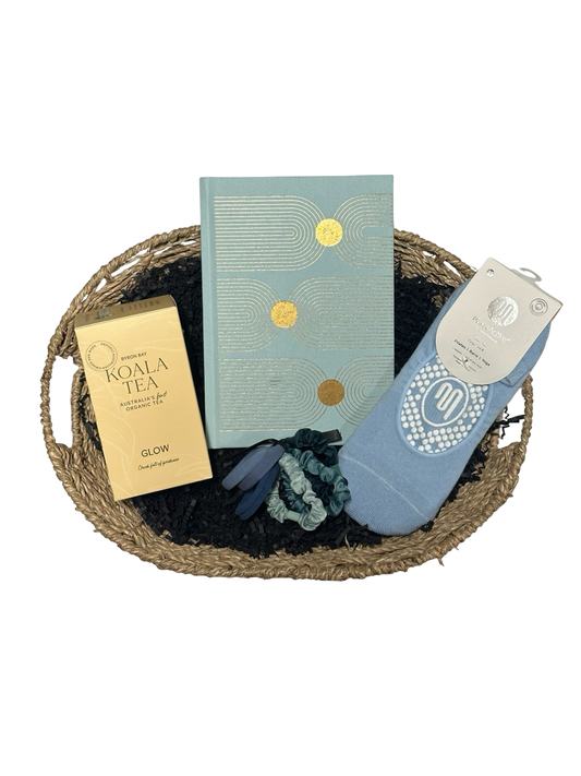 Basket with a book, soap, and other items on a white background
