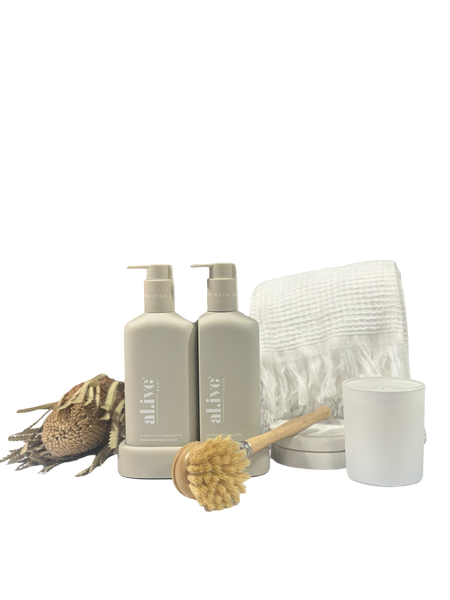 Set of bathroom products including bottles, a brush, and a towel on a white background