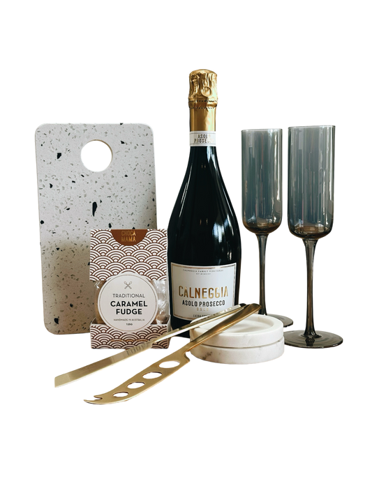 Terrazzo Board, gold knives, bottle of Prosecco, fudge and charcoal smoked glass flutes