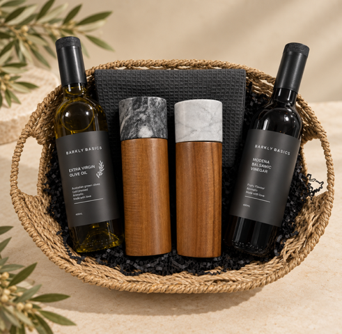 Olive Oil and Vinegar  bottles and wooden items in a woven basket on a beige background