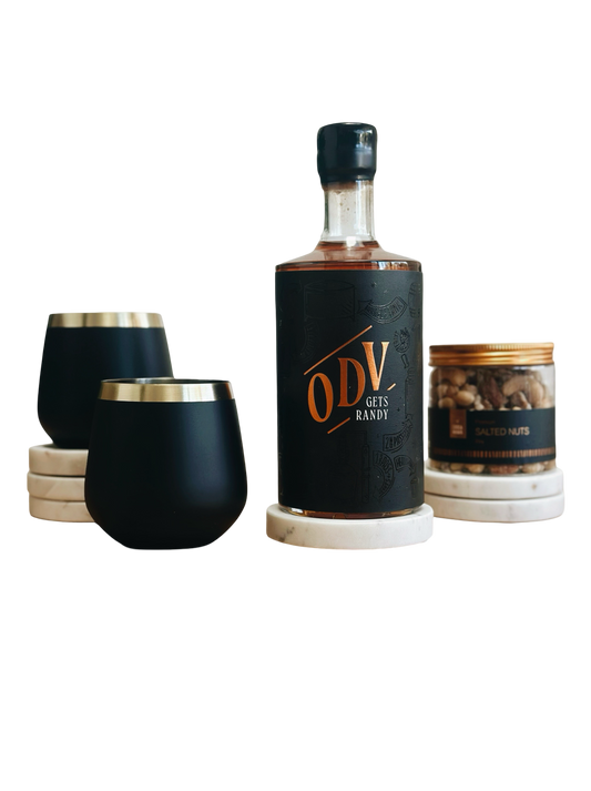 Bottle of ODV with two black stemless glasses on a white background