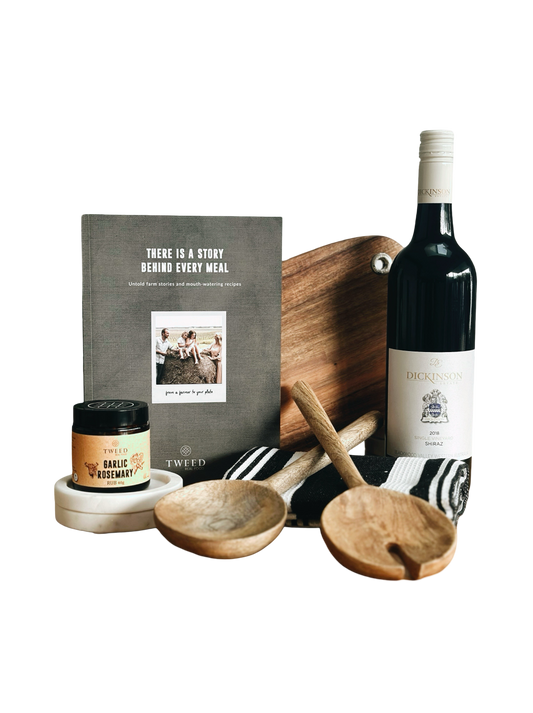 Wine bottle, wooden cutting board, and kitchen items on a white background