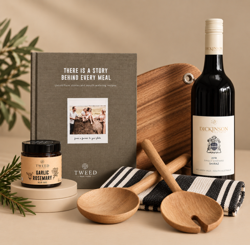 Cookbook, Wine bottle, wooden cutting board, and kitchen items on a green background