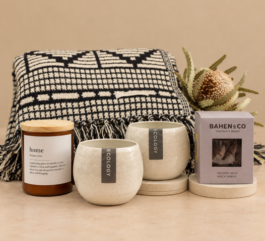 Set of candles and a blanket with 'Bahen & Co' branding on a beige background